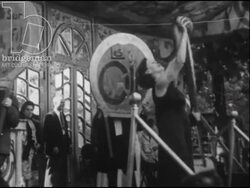 Fairground in full swing - acrobatics, dogs doing tricks, belly dancer; clowns, etc. France 1947 Stock Footage