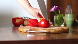 Female hands cutting tomato Stock Footage