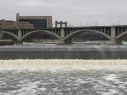 The Mississippi River, St. Anthony falls, shown flowing from Minneapolis minnesota  Stock Footage