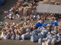 September 13, 2005 aerial medium shot relief workers sorting boxes at relief camp / Slidell, Louisiana Stock Footage