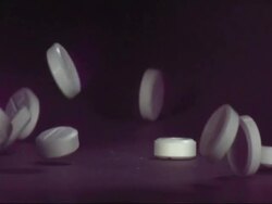 SLOMO CU paracetamol pills falling on to surface Stock Footage