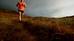 SLO MO trail runner running on the mountain plateau Stock Footage