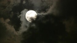 Dark clouds drift across a full moon. Stock Footage