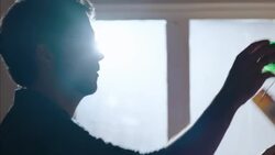 Small business owner hangs price tag on specialty longboard in skate shop Stock Footage