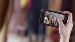 Two young women make funny faces and take selfies with smartphone Stock Footage