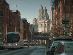 Traffic on the east side of Manhattan by Madison Street & Rutgers Street in New York City.  The Woolworth Building is behind and the Manhattan Bridge is in the middle of the frame. Stock Footage