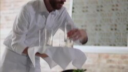 Waiter places clean drinking glasses on restaurant table Stock Footage