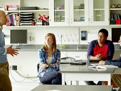 Teacher working with students in classroom Stock Footage