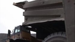 A dump truck bed lifts up to empty its contents. Stock Footage