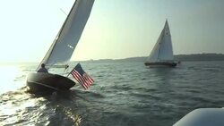 A red hulled Morris M29 sailboat sails through the water off Castle Hill in Newport, Rhode Island. Stock Footage