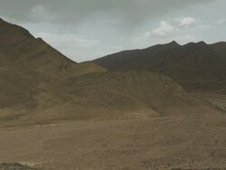 Mountains lead down to a dry river valley. Stock Footage