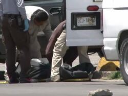 MS TS View of Dead body keep on stretcher at gun shot victim on streets AUDIO / Ciudad Juarez, Juarez, Mexico Stock Footage
