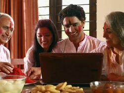 Family celebrating holi festival on the laptop Stock Footage