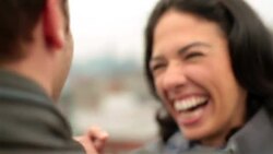 Young woman in love laughs and kisses boyfriend on Brooklyn rooftop Stock Footage