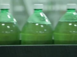 CU Soda bottles on filling line / soda manufacturing and bottling. Stock Footage