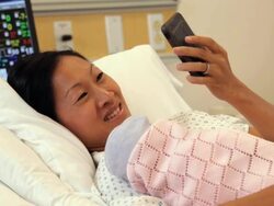 "patient in hospital with newborn talking on a smart phone /Richmond,Virginia, USA" Stock Footage