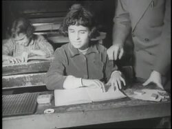 Blind school children work at their desks and read Braille text books. News Clip