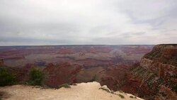 Young boy looks out at the Grand Canyon with binoculars (pan) Stock Footage
