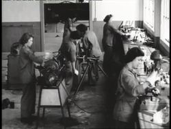 Women work in a machine shop during World War II. News Clip