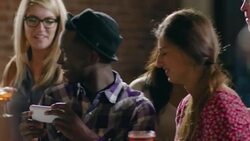 Friends gather around smartphone to take group selfie at restaurant bar Stock Footage