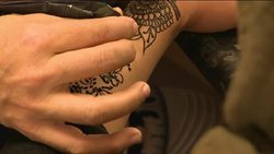Henna tattoo being applied in a shop News Clip