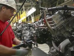 MS Shot of Worker installing components on an internal combustion engine in an auto assembly plant / Princeton, Indiana, United States Stock Footage