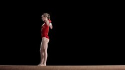 LD Female gymnast doing her routine on balance beam Stock Footage