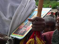 Young Ethiopian man carrying image of saint Stock Footage