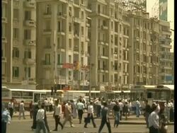 MS city centre street with pedestrians and traffic, Apartments in background, Egypt Stock Footage