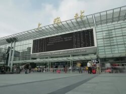 TL WS Shanghai Railway Station with big screen and people walking in foreground / Shanghai, China Stock Footage