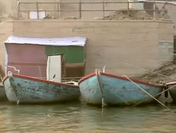 MS POV View of boats with people at ghats near Ganges River / Varanasi, Uttar Pradesh, India Stock Footage