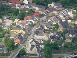 MS AERIAL ZO Shot of houses running vehicles on road at Saalburg / Germany Stock Footage