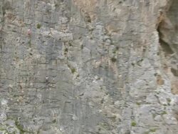 MS ZI AERIAL Shot of caves with climbers climbing on cliff / Kalymnos, Cyclades, Greece Stock Footage