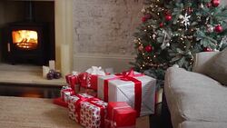 Christmas presents between Christmas tree and fire in wood stove Stock Footage