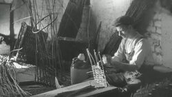 MONTAGE Basket weaver weaving reeds into a shape Stock Footage