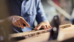 Expert craftsman chisels wood in workshop Stock Footage