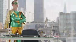 Superhero standing in business office Stock Footage