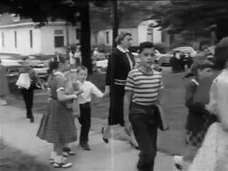 B/W 1950s PAN pro-segregation women protestors walking with children on sidewalk / newsreel Stock Footage
