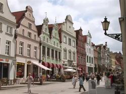 WS Pedestrian area with people walking in front of baroque facades / Wismar, Mecklenburg-Western Pomerania, Germany Stock Footage