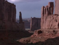 ZO Red rock formations under the sun casting shadows on a canyon in Arches National Park / Utah, United States Stock Footage