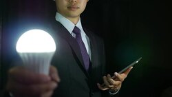Businessman Holding Light Bulb and tablet Stock Footage