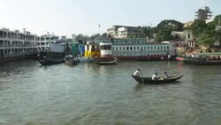 Sadarghat Launch Terminal in Dhaka Bangladesh is a bustling passenger transport hub where tiny wooden boat taxis paddle alongside huge steel ferries Stock Footage