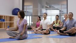 Meditating in Lotus Position in Fitness Class Stock Footage