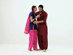 Punjabi couple watching a digital camera and hugging  Stock Footage