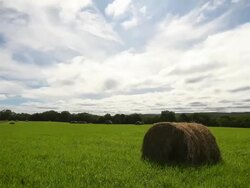 clouds over hay bales Stock Footage