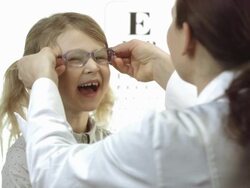 HD: Ophthalmologist Putting Glasses On Little Girl Stock Footage
