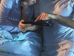 HD CRANE: Mother And Daughter Using Tablet In Bed Stock Footage