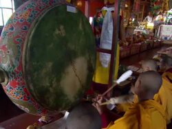 MS Young Buddhist monks playing  large drum at  Kopan Monastery  / Kathmandu, Central, Nepal Stock Footage
