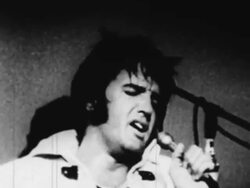 Elvis Presley sings before a live audience in Las Vegas Stock Footage