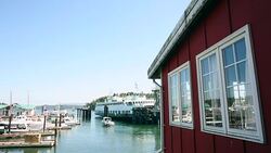 A scene from downtown Friday Harbor with a ferry boat exiting the terminal onto the Puget Sound. Stock Footage